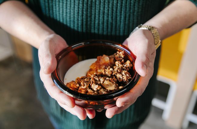 Holding a bowl of granola.