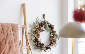 Dried flower wreath hanging on wall.