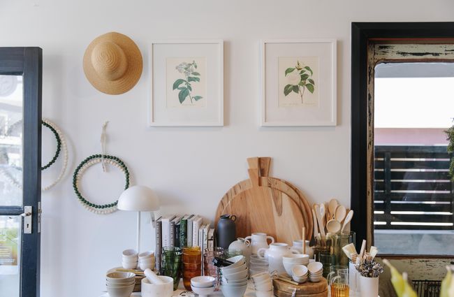 Homewares on a table and artwork on the wall at Harakeke Florist in Christchurch.