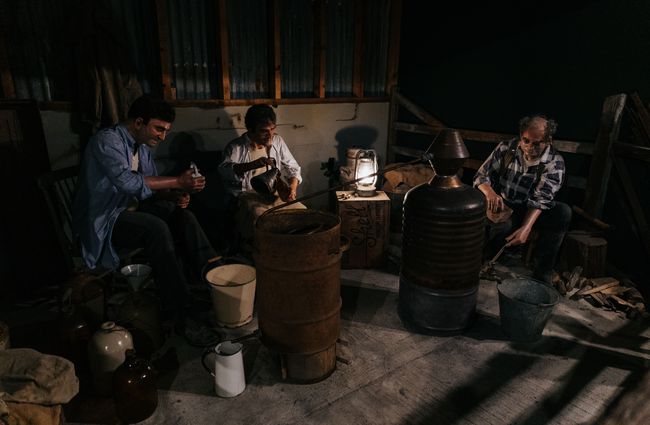 An exhibition of mannequins making moonshine.