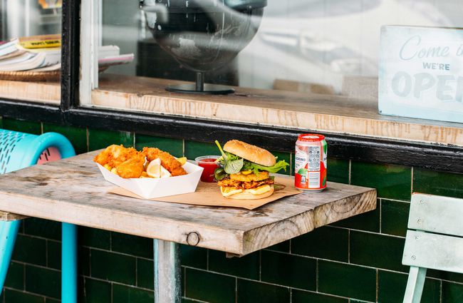 Fish and chips and burgers on an outside table out front of Huckle & Co.