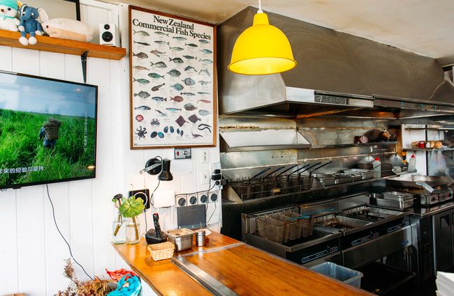 The inside of the kitchen at Huckle and Co with an iconic fish poster on the wall.