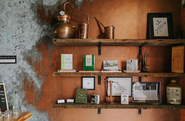 Gin books and paraphernalia on shelves on a wall inside Humdinger Gin Distillery in Geraldine.