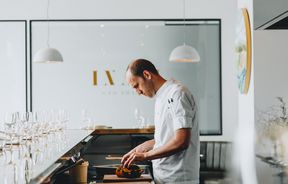 Th chef Simon Levy working in the kitchen inside Inati restaurant Christchurch, New Zealand.