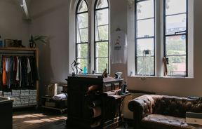 Interior view of the historic windows and leather chesterfield at Indigo & Provisions, Christchurch.