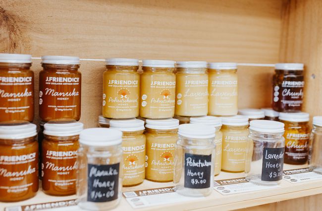 Row of honey jars stacked up on a shelf at J Friend & Co Honey, Christchurch