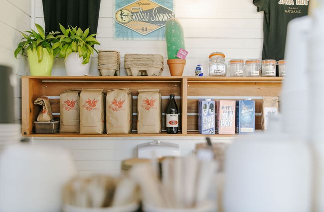 Coffee beans and milk cartons on a shelf at Java Hut, Māpua.