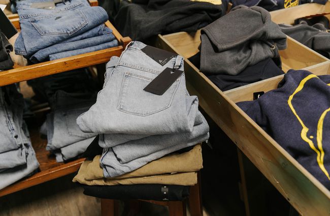 Folded pile of jeans for sale at Kaikōura Surf Company.