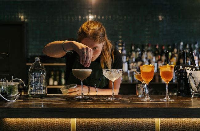 Woman making a cocktail at Kika.