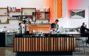 Barista pours coffee behind the counter at Miltons Canteen, Hamilton.