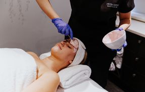 Produce being applied to a face during a facial.