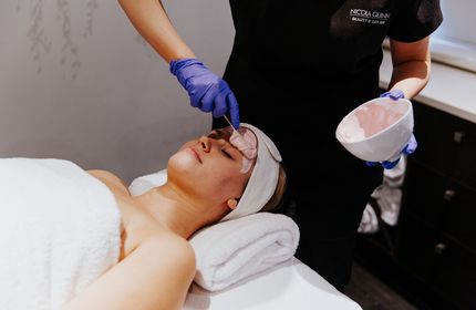 Produce being applied to a face during a facial.