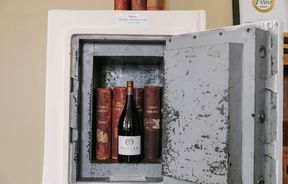 Close up of wine and a couple of books kept in a safe at Vinters Drop in Kurow, Waitaki.