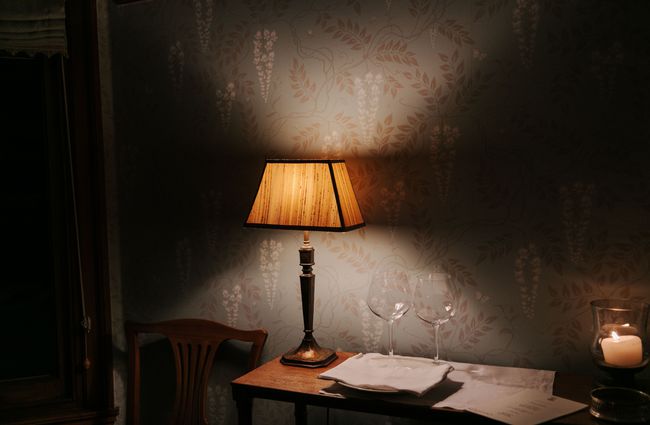 Wine glasses next to a lamp.