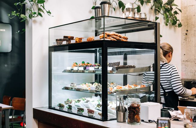 Glass cabinet of cakes and treats at Ozone Coffee Roasters, New Plymouth.