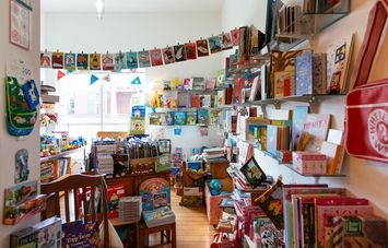 Colourful books hanging up inside Paige's Book Gallery in Whanganui.
