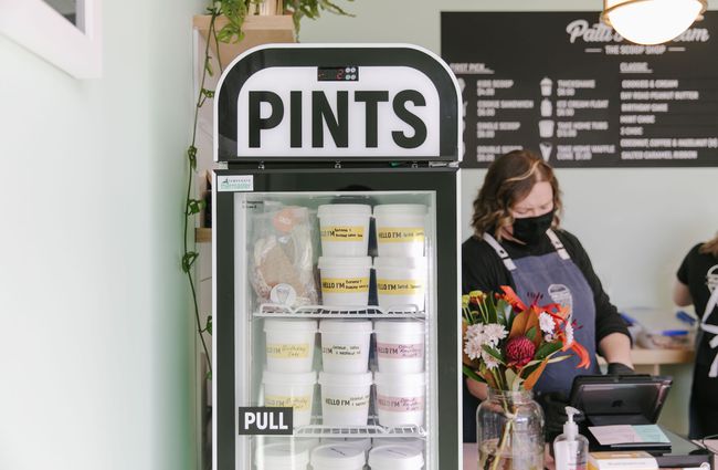 Pints of ice cream for sale in fridge at Patti's and Cream.