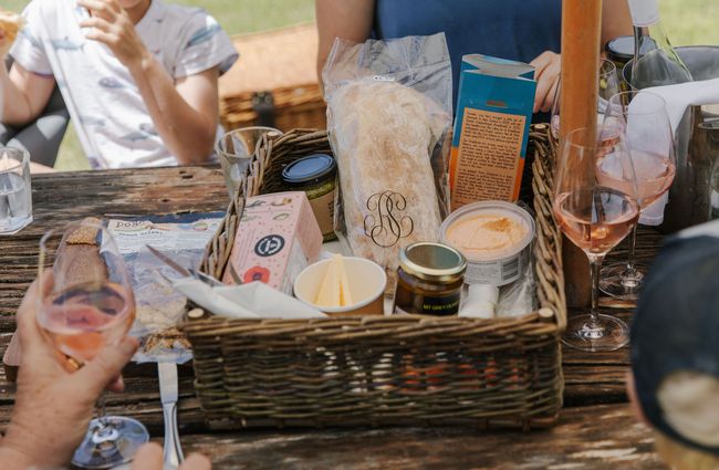 Basket of deli goodies and wine on the table at Pegasus Bay.