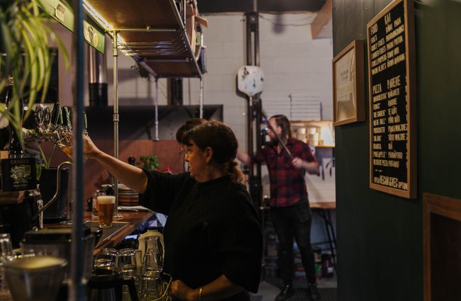 Woman pouring a beer from the tap.
