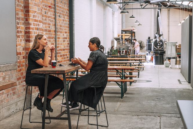 Two woman having a coffee at a leaner table at Red Rabbit, Auckland.