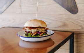Chicken burger on a table.