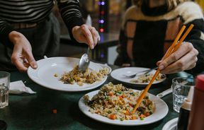 Close up of customers serving themselves fried rice.