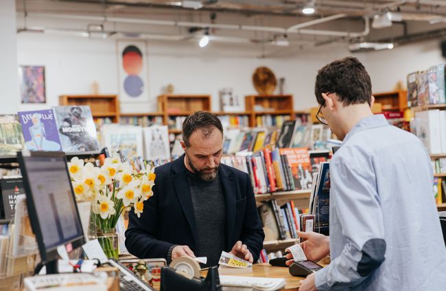 A man buying a book.