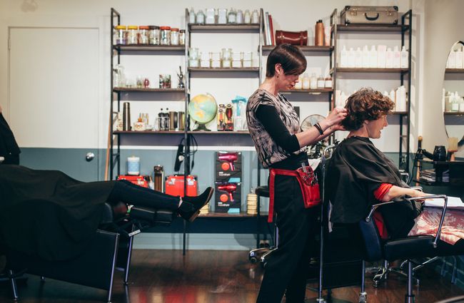 A woman cutting hair.