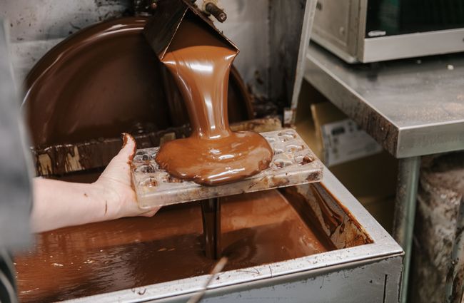 Melted chocolate coming out of machinery at Seriously Good Chocolate Company.
