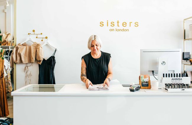 Woman working behind counter at Sisters on London, Hamilton.