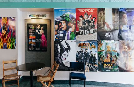 Close up of movie posters on a wall.