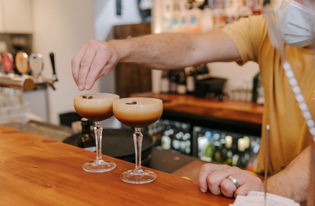 Putting coffee beans on espresso martinis at Sumner Social, Christchurch.