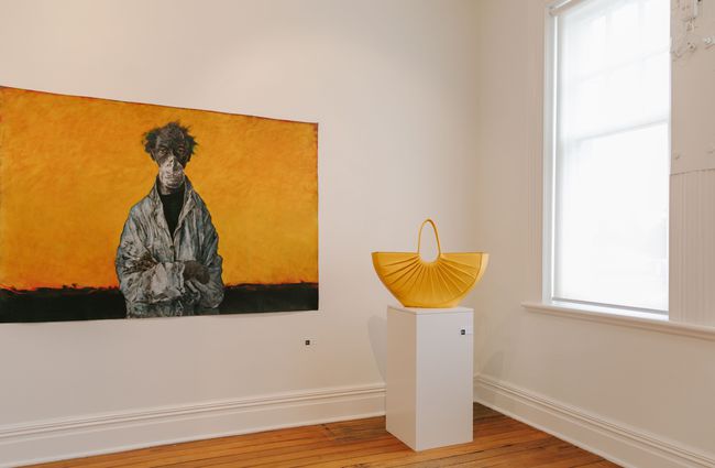 Yellow artwork with yellow handbag on plinth at Susan Badcock Gallery,  Geraldine.
