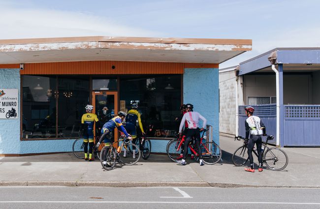 A group of cyclists parking up their bikes outside the cafe.
