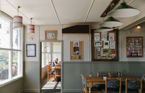 Seating area with noticeboard on the wall at The Moutere Inn, Nelson Tasman.