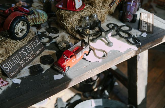 A close up of vintage cars and old tools on a table at Three Creeks.