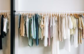Close up of feminine clothes on a rack.