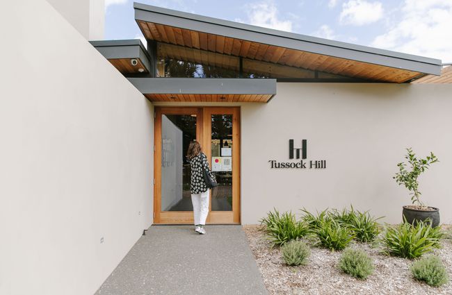 Woman walking into the entrance of Tussock Hill Vineyard, Christchurch.
