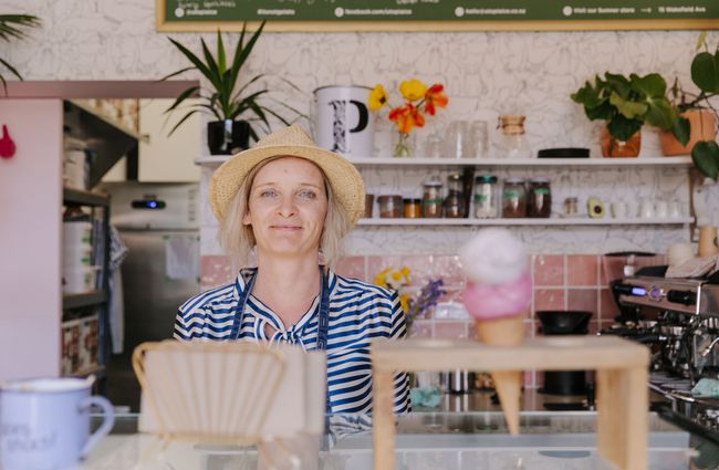 Woman in a straw hat waiting to serve ice creams.
