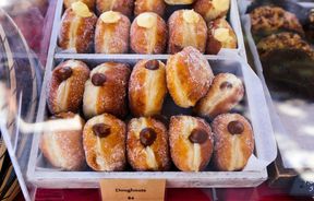 Doughnuts on a table ready for sale.