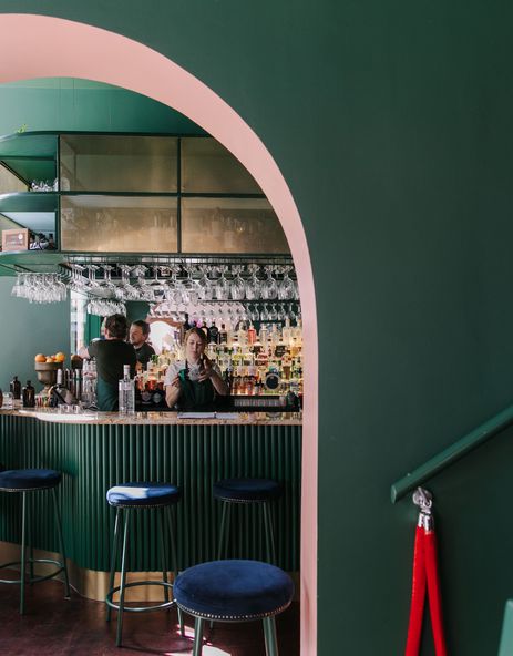 Interior view of gin gin feature green and pink contrast archway.