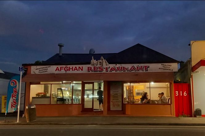 Afghan Restaurant exterior at nighttime.