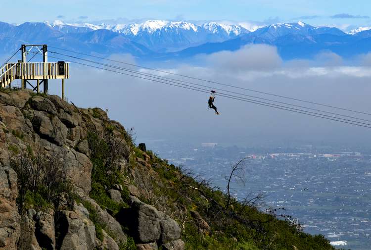 Someone zip-lining at Christchurch Adventure Park in the Port Hills, Christchurch.