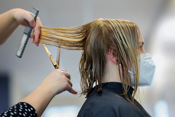 Close up of woman having her hair cut.