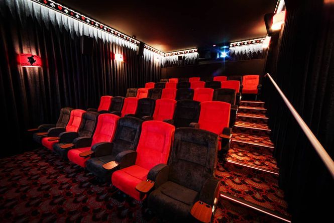 The red seating area inside Alice Cinemas.