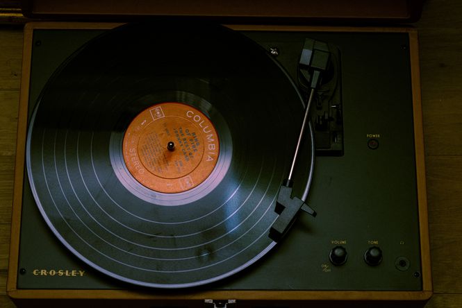 Record on vintage looking record player by Joe Vasquez. .