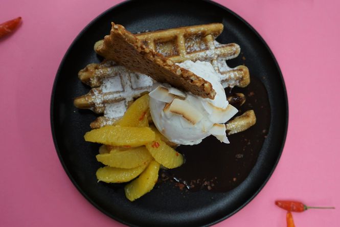 A flatlay close up of Utopia Ice's waffles on a pink table.