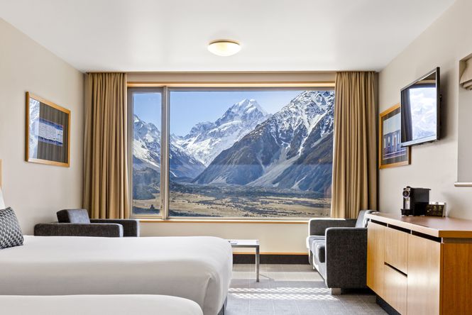 Looking out of a hotel room at a view of snow covered mountains in Mt Cook.