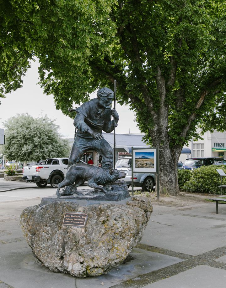 A sculpture of a man and his dog.