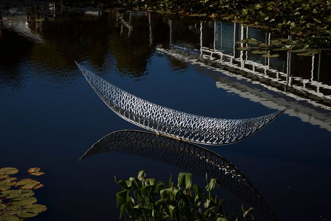 A sculpture boat on water.